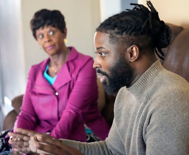 Lora Hyler, left, listens while Gerald Williamson Jr. talks about his childhood experiences with his great, great uncle Zeddie Quitman Hyler. Lora is the niece of Zeddie.