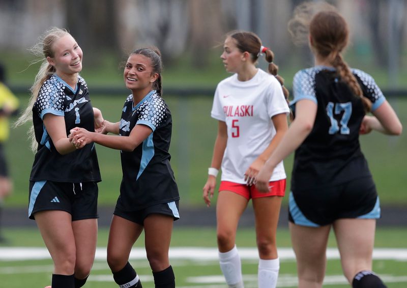 Xavier High School's Sydney Neilitz (1) celebrates with Gabby Wasco (6) after scoring a goal against Pulaski High School during their girls soccer game Friday, April 17, 2026, in Appleton, Wisconsin. Xavier won 3-1.