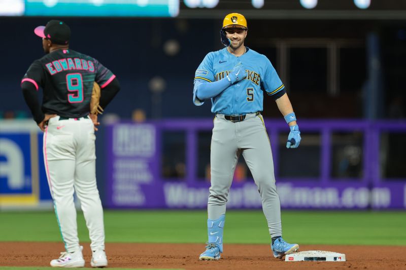 Brewers center fielder Garrett Mitchell (5) celebrates at second base after hitting a two-run double against the Marlins during the 10th inning on Friday, April 17 at loanDepot Park in Miami.