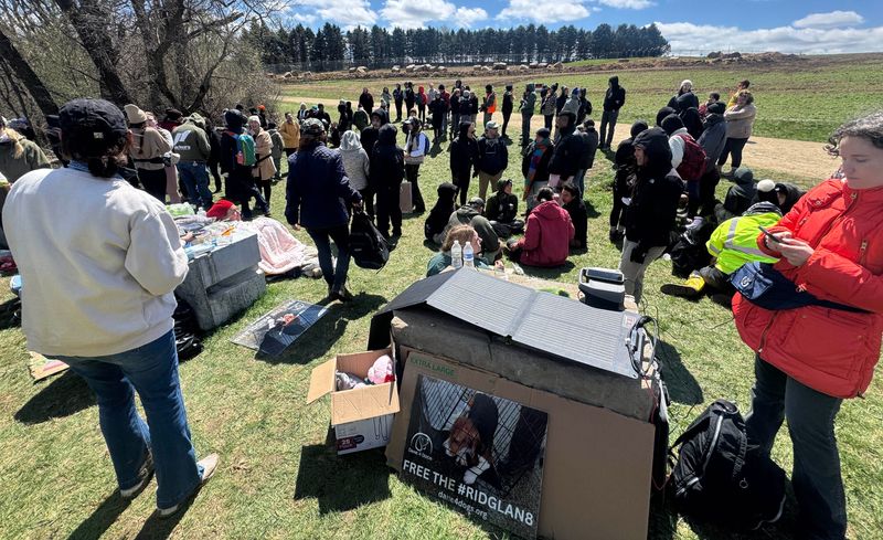 People gather near the medical research dog breeder Ridglan Farms Saturday, April 18, 2026 in rural Dane County near Blue Mounds, Wisconsin. Ridglan Farms is licensed by the state as a dog breeding operation. It breeds thousands of beagles and sells them to laboratories for medical and scientific testing and has operated for nearly 60 years.