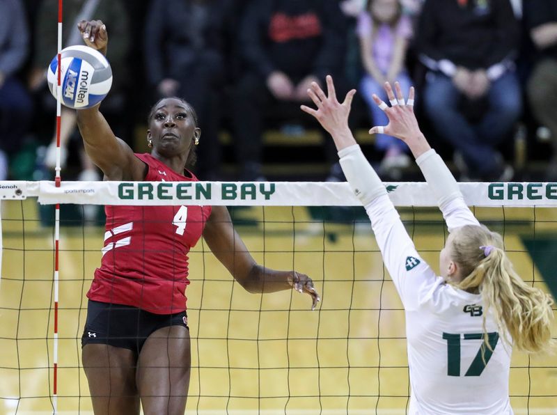 Wisconsin's Jaela Auguste hits against Wisconsin-Green Bay during an exhibition match April 18 at the Kress Center in Green Bay.