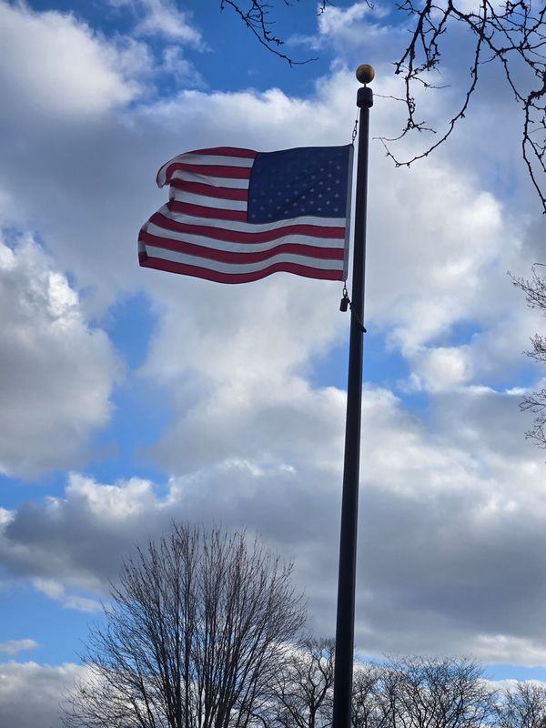 A U.S. flag in Oshkosh, Wis., near Lake Winnebago blows in the wind on a spring day.