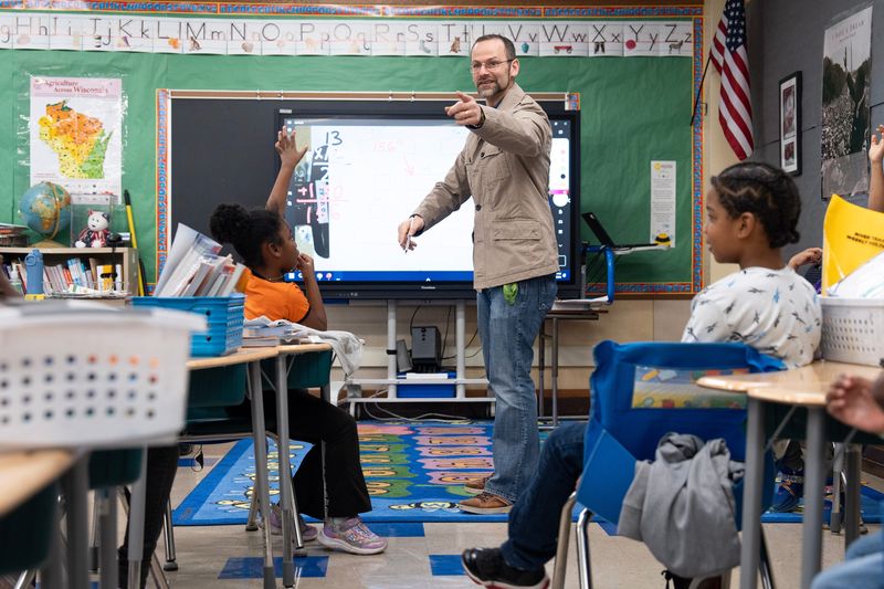 Joshua Gonzalez leads a math lesson for his second grade students, calculating the area of a garden bed after measuring them outside with his students at River Trail School of Agricultural Science in Milwaukee, Wisconsin, on the afternoon of April 9, 2026.