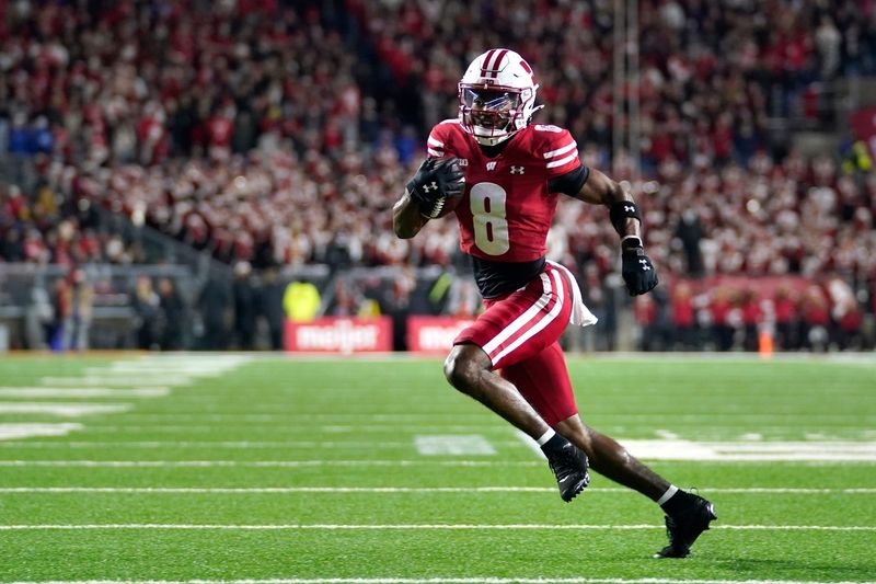 Nov 22, 2025; Madison, Wisconsin, USA; Wisconsin Badgers wide receiver Vinny Anthony II (8) runs the ball for a touchdown during the first quarter against the Illinois Fighting Illini at Camp Randall Stadium. Mandatory Credit: Kayla Wolf-Imagn Images