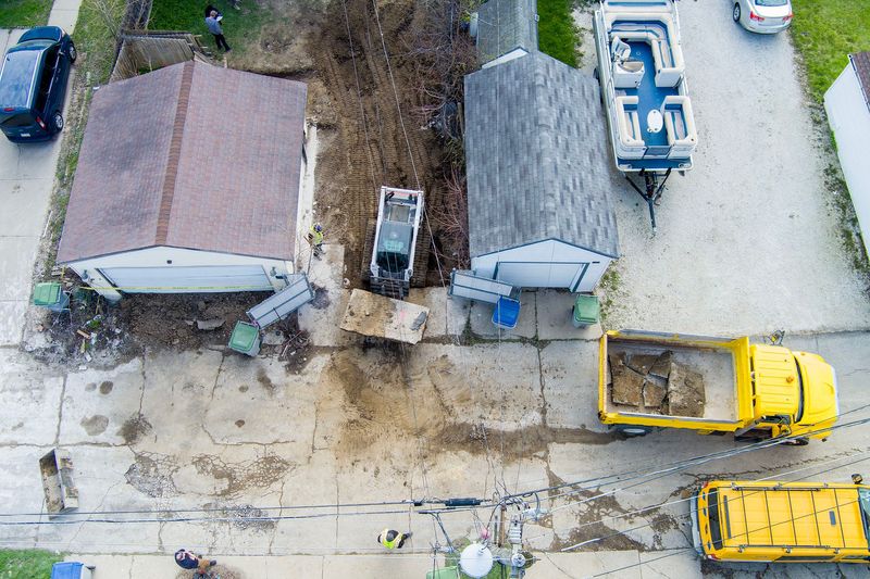 Concrete slabs are removed as Milwaukee police search in the yard of a home once owned by notorious Milwaukee drug dealer Michael Lock in Milwaukee, on April 21, 2026. The search included detectives excavating the property at 4343 N. 15th Street as they looked for the remains of homicide victims at a home now listed in city tax records as owned by Shalanda Roberts, formerly Shalanda Lock, who was once married to Michael Lock.