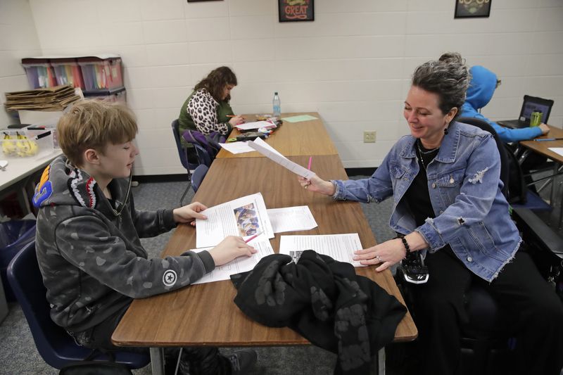 Janeal Spring, an alternative education teacher for Appleton East High School, gives some guidance to student Michael Ebbinger on April 15.