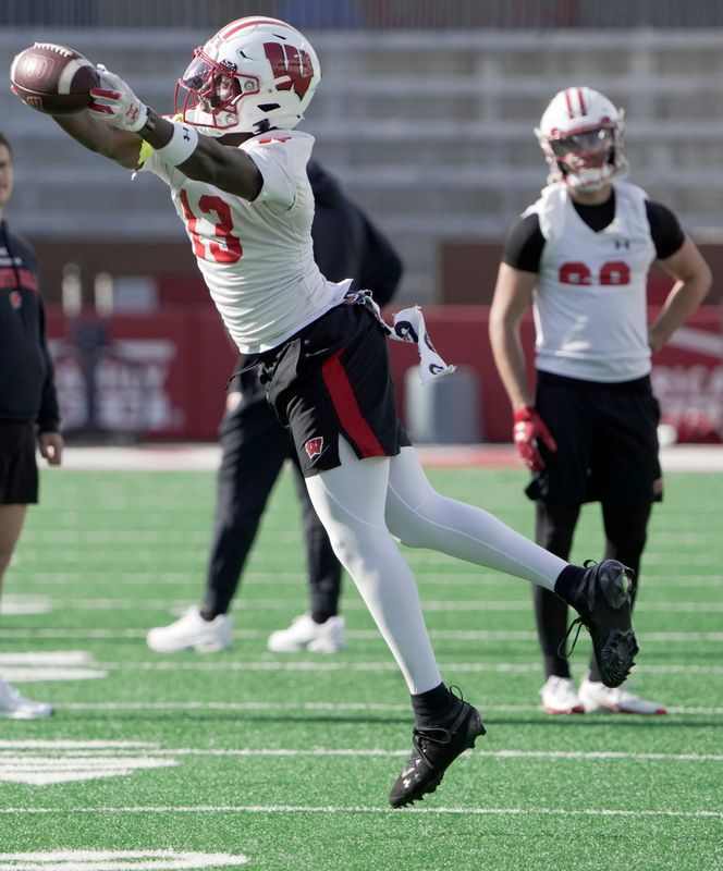 Wisconsin wide receiver Eugene Hilton Jr. (13) put his name into the transfer portal in December, but he then recommitted after the Badgers were especially active during the first week of the portal this month.