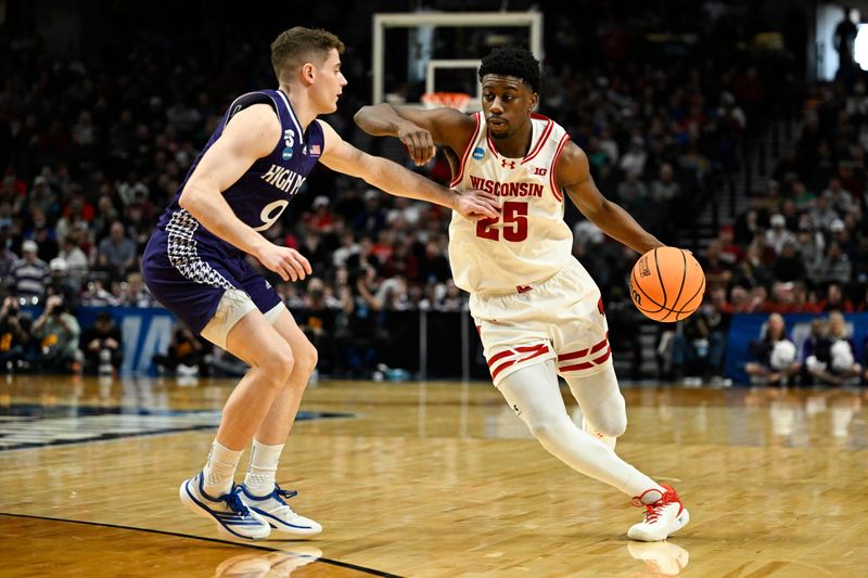 Mar 19, 2026; Portland, OR, USA; Wisconsin Badgers guard John Blackwell (25) drives against High Point Panthers guard Conrad Martinez (9) during the second half of a first round game of the men's 2026 NCAA Tournament at Moda Center. Mandatory Credit: Troy Wayrynen-Imagn Images