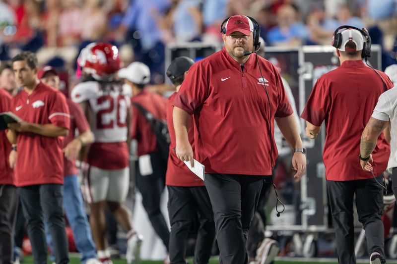 Wisconsin offensive line coach Eric Mateos walks the sideline last season when he held that position at Arkansas.