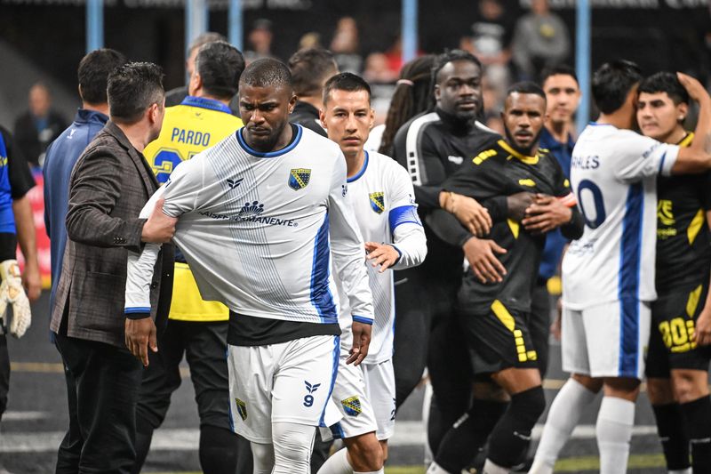 San Diego Sockers forward Tavoy Martin (9) walks away angrily and Milwaukee Wave forward Ian Bennett (26) is restrained by goalkeeper William Banahene as tempers flare after MASL finals Game 1 on April 22 at the UWM Panther Arena.