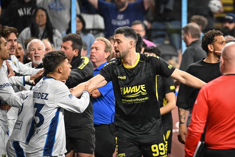 Milwaukee Wave forward Andre Hayne (99) holds back San Diego Sockers midfielder Sebastian Mendez as tempers flare after their game  April 22 at the UWM Panther Arena.
