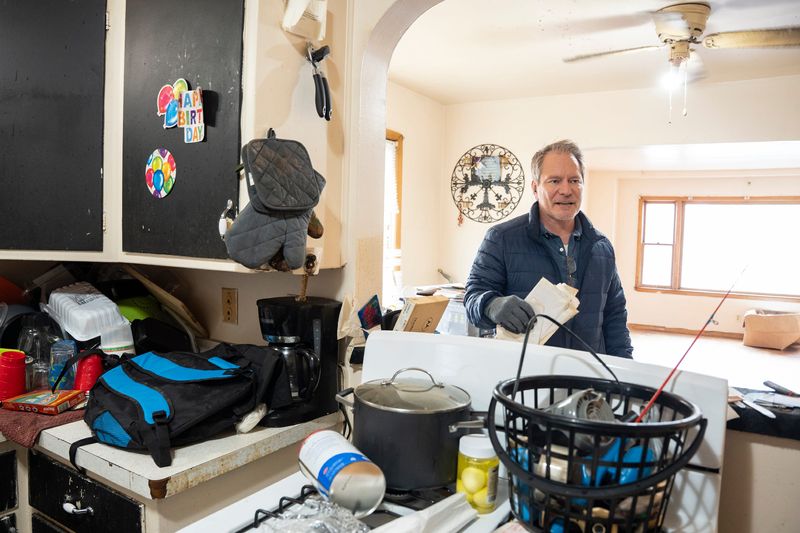 Sam Stair, the owner of S2 Real Estate, accesses a unit after a tenant’s abrupt departure on April 1, 2026, in Milwaukee, Wisconsin.