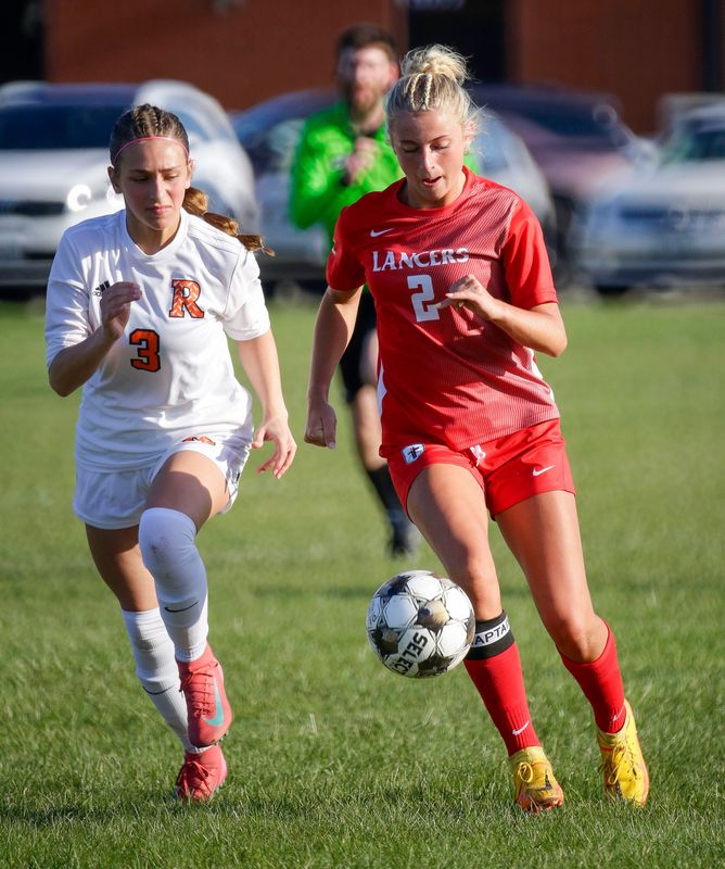 Cedar Grove-Belgium’s Claire Prinsen (3) and Manitowoc Lutheran’s Stevie Brunner (2) chase the ball at Manitowoc Lutheran, Thursday, April 23, 2026, in Manitowoc, Wis.