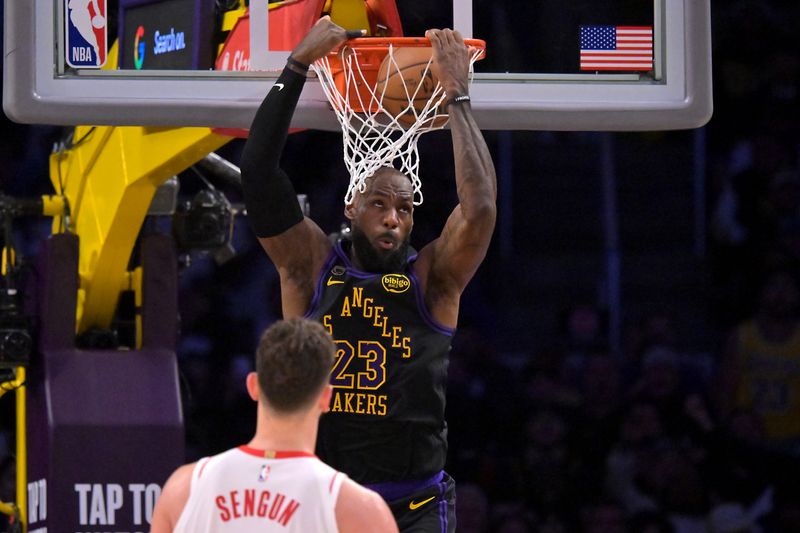 Los Angeles Lakers forward LeBron James (23) dunks as Houston Rockets center Alperen Sengun (28) looks on during Game 2 of their first-round playoff series on April 21, 2026.
