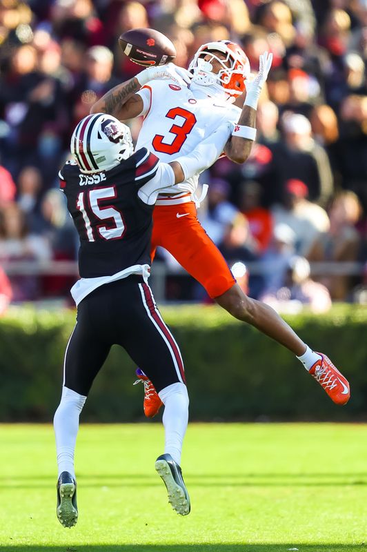 Nov 29, 2025; Columbia, South Carolina, USA; South Carolina Gamecocks cornerback Brandon Cisse (15) breaks up a pass intended for Clemson Tigers wide receiver Tristan Smith (3) in the third quarter at Williams-Brice Stadium. Mandatory Credit: Jeff Blake-Imagn Images