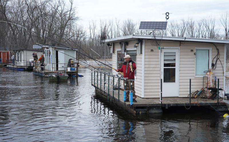 Anglers utilize fishing rafts April 11, 2026 on the Wolf River near Fremont during the annual spring walleye migration. The rafts, which typically feature bunk beds and a kitchen, are a local fishing tradition.