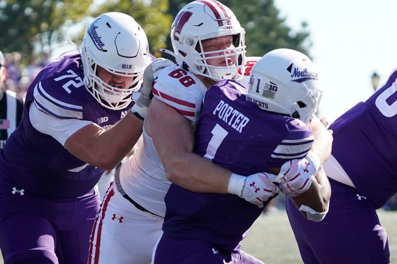 Oct 19, 2024; Evanston, Illinois, USA; Wisconsin Badgers defensive lineman Ben Barten (68) tackles Northwestern Wildcats running back Cam Porter (1) during the second half at Lanny and Sharon Martin Stadium. Mandatory Credit: David Banks-Imagn Images
