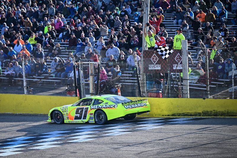 Ty Majeski takes the checkered flag to win the Jerry Priesgen Memorial 100 on April 26 at Slinger Speedway for his 41st ASA Midwest Tour victory.