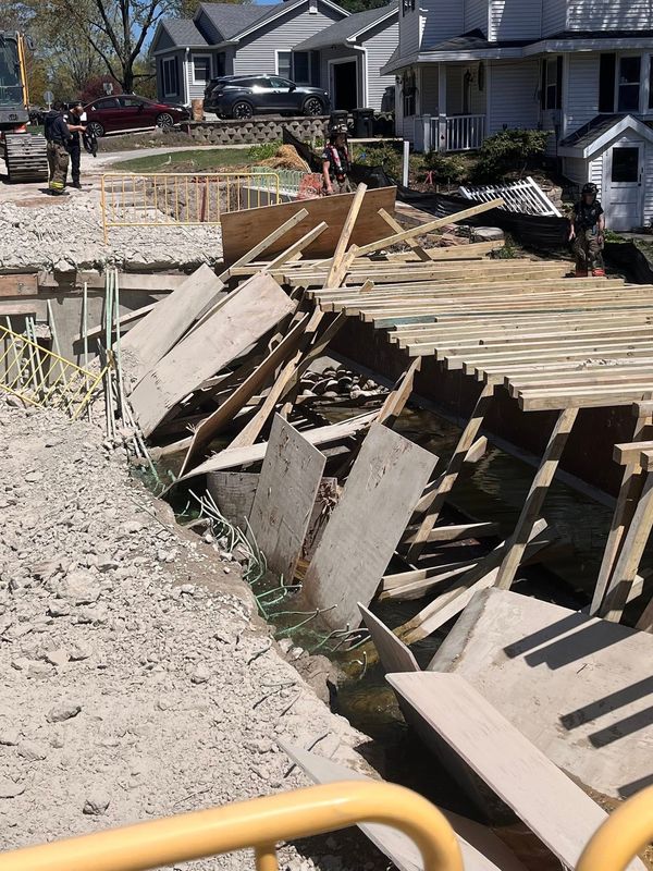 Western Lakes Fire District personnel survey the damage after the under-construction Lapham Street Bridge collapsed April 25 in Oconomowoc. The single-lane bridge, south of Washington Street, was in the process of being rebuilt into a two-lane structure when the collapse occurred.