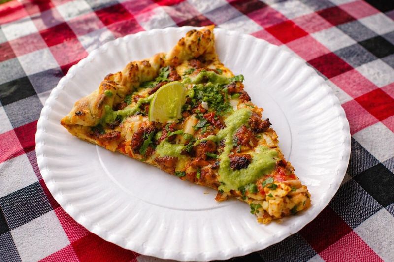 The Al Pastor Pizza from Charlie’s Pizza is made with marinated al pastor pork, mozzarella cheese and pineapple. It's a 2026 Wisconsin State Fair Sporkies finalist.
