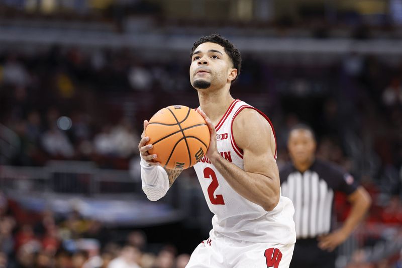 Mar 12, 2026; Chicago, IL, USA; Wisconsin Badgers guard Nick Boyd (2) shoots a free throw against the Washington Huskies during the second half at United Center. Mandatory Credit: Kamil Krzaczynski-Imagn Images