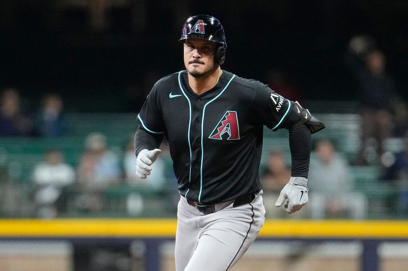 Diamondbacks third baseman Nolan Arenado rounds the bases after hitting a home run against the Brewers in the fifth inning at American Family Field.