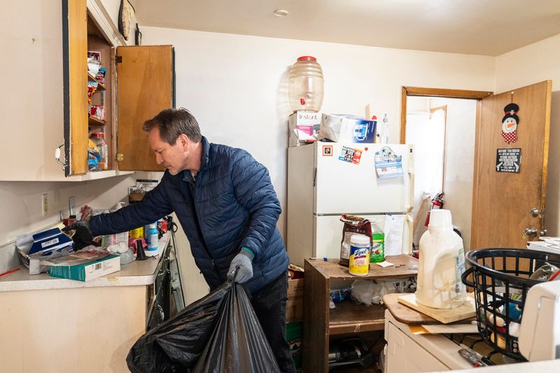 Sam Stair, the owner of S2 Real Estate, cleans up a unit after a tenant’s abrupt departure on April 1, 2026, in Milwaukee, Wisconsin. “It was like a drug issue. They got raided by the police,” said Stair.