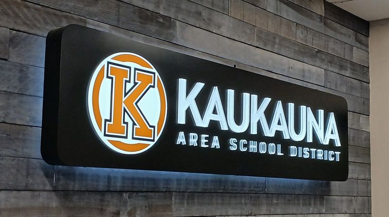 A lighted plaque hangs over the front desk at Kaukauna Area School District April 30, 2026 in Kaukauna, WI.