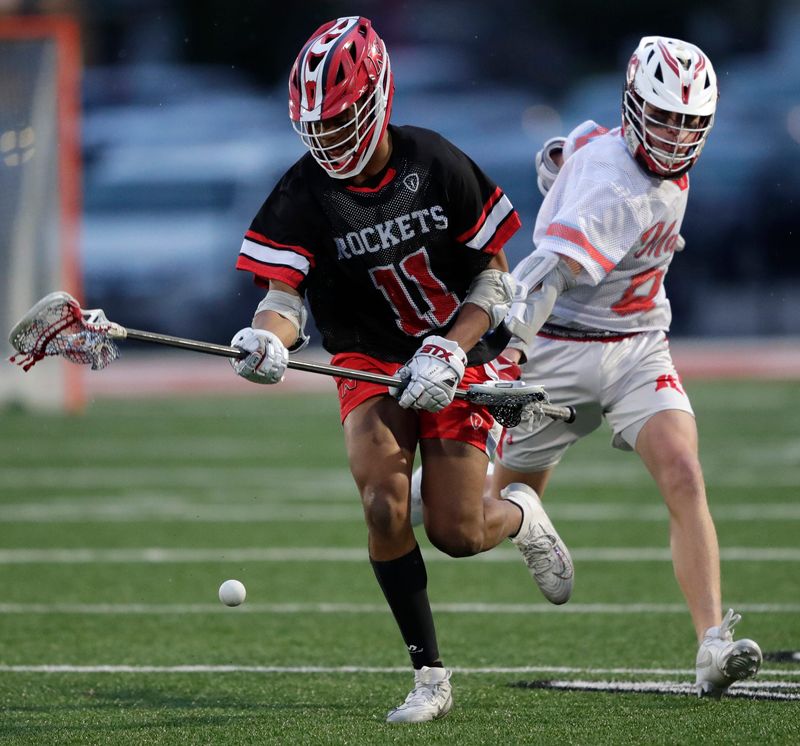 Neenah High School's ReShawn Vaughn (11) has the lacrosse ball knocked away from by Kimberly High School's Parker Janssen (8) during their boys lacrosse game Thursday, April 30, 2026, in KImberly Wisconsin. Neenah won 5-4.