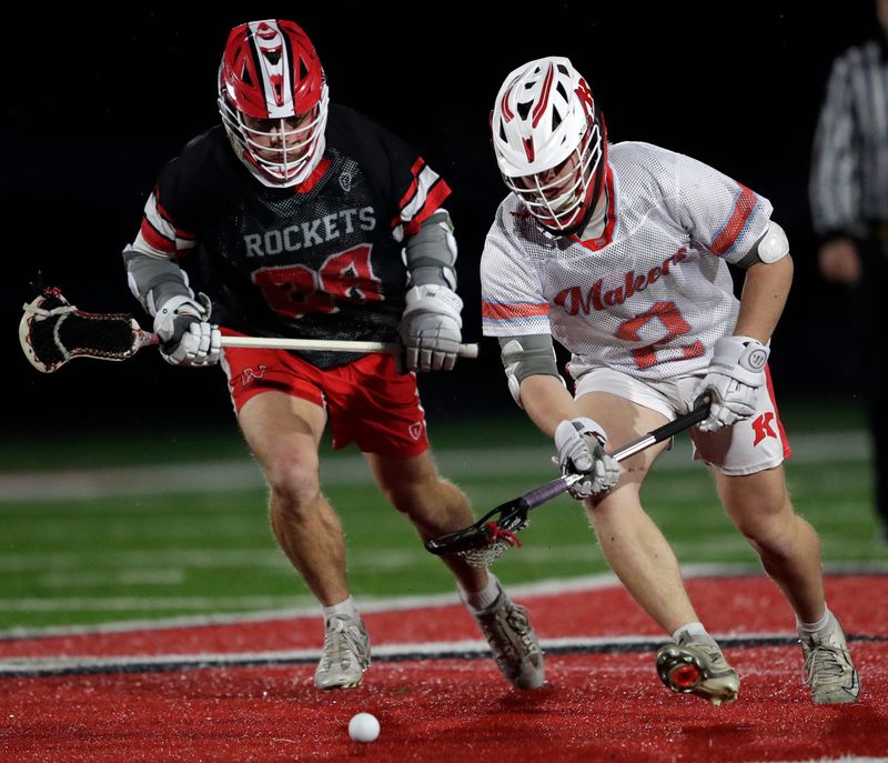 Neenah High School's Troy Kahler (28) pursues Kimberly High School's Brady Reinke (2) during their boys lacrosse game Thursday, April 30, 2026, in KImberly Wisconsin. Neenah won 5-4.