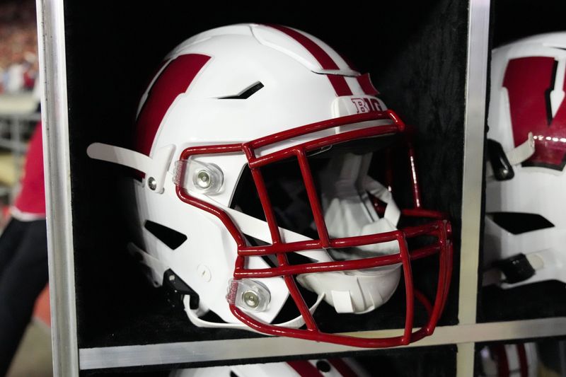 Aug 28, 2025; Madison, Wisconsin, USA; General view of a Wisconsin Badgers football helmet on the sidelines during the game against the Miami (OH) RedHawks at Camp Randall Stadium. Mandatory Credit: Jeff Hanisch-Imagn Images