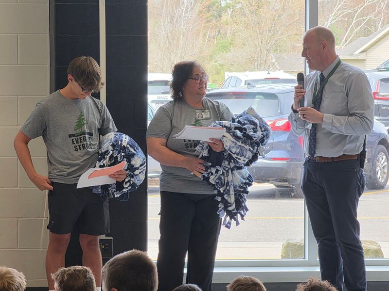 Principal Kevin Kampmann recognized and gave gifts to custodial workers at an all-school assembly on May 4 to celebrate the reopening of the school building which was damaged by an EF3 tornado on April 17, 2026.