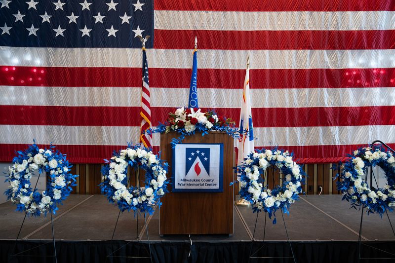 Memorial wreaths are placed in front of the podium during the 2026 Greater Milwaukee Law Enforcement Memorial Ceremony at the Milwaukee County War Memorial Center on the afternoon of May 6, 2026 in Milwaukee, Wisconsin.