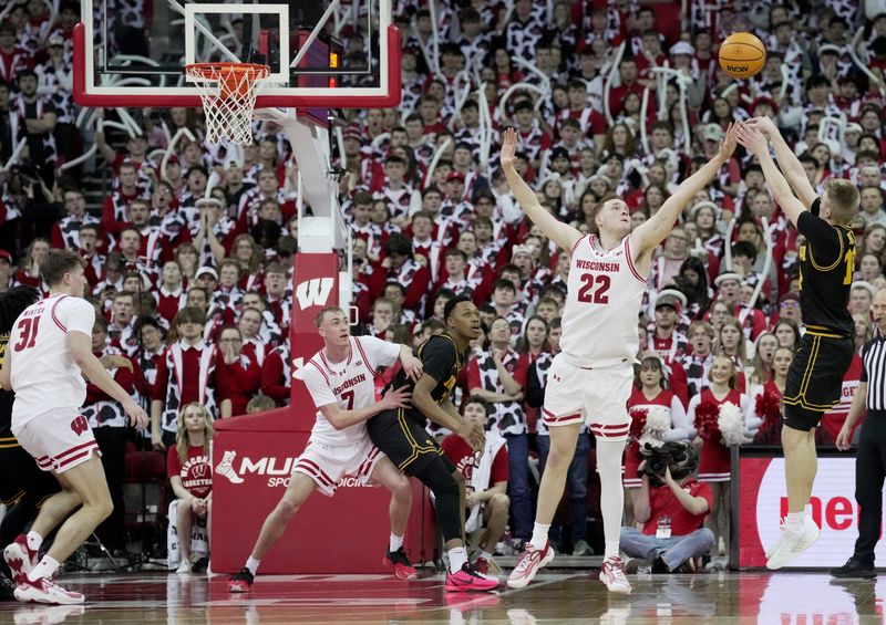 Iowa guard Bennett Stirtz (14) hits a three-point basket over Wisconsin forward Austin Rapp (22) during the second half of the game Sunday, February 22, 2026 at the Kohl Center in Madison, Wisconsin. Wisconsin beat Iowa 84-71.