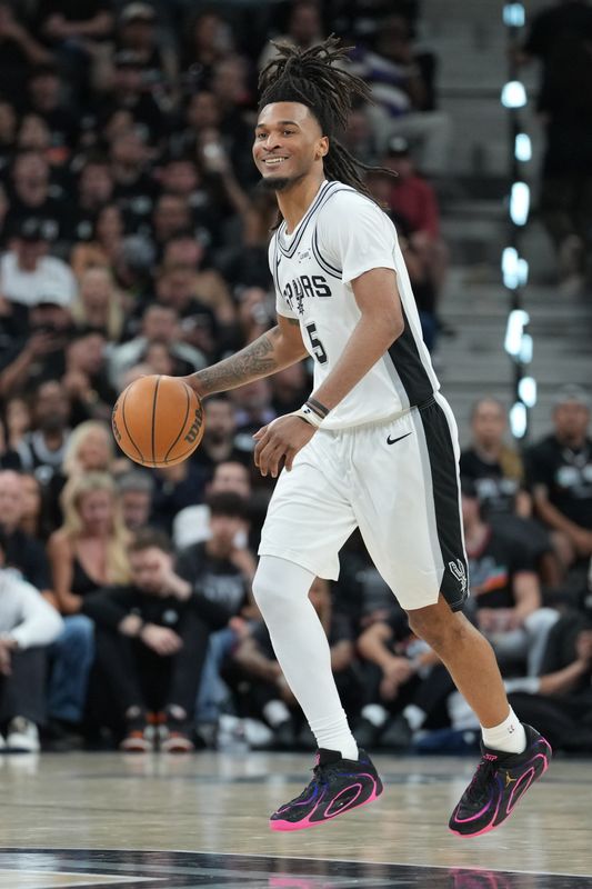 May 6, 2026; San Antonio, Texas, USA; San Antonio Spurs guard Stephon Castle (5) smiles as he dribbles up the court in the second half against the Minnesota Timberwolves during game two of the second round of the 2026 NBA Playoffs at Frost Bank Center. Mandatory Credit: Daniel Dunn-Imagn Images