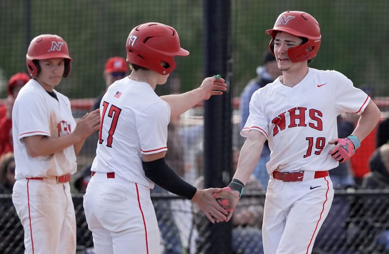 Neenah High School's Davison Rhodes (17) congratulates Max Miller (19) after he drove in three runs against Appleton West High School to end their baseball game Friday, May 8, 2026, at Neenah High School in Fox Crossing, Wisconsin. Neenah won 13-1.