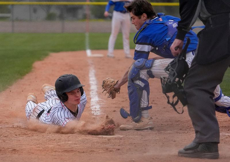 New London High School's Darrian Rice (14) dives safely into home plate to score a run against Wrightstown High School on Friday, May 8, 2026, at Wrightstown High School in Wrightstown, Wis. New London won the game, 12-7.
Tork Mason/USA TODAY NETWORK-Wisconsin