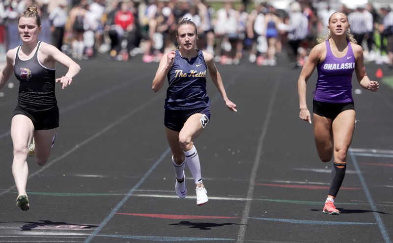 Denmark’s Ella Denor, left, wins with 100-meter heat with a time of 12.26 during the Myrhum Invitational Saturday, May 9, 2026 at Arrowhead High School in the Town of Merton, Wisconsin. Also shown are Kettle Moraine’s Caitlin Blawat, center, and Onalaska’s McKena McGarry.