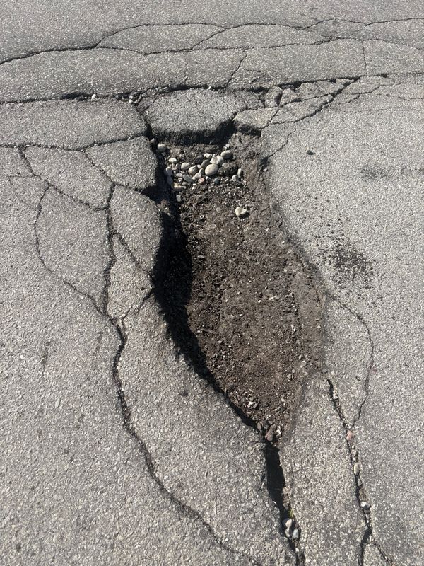 This is not the surface of the moon; it's a large pothole in Greendale, near Southridge Mall. Potholes are widespread throughout southeastern Wisconsin, and the damage they cause to cars is impacting people's wallets.