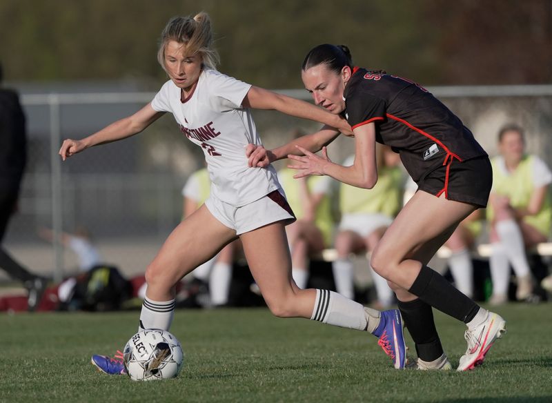 Winneconne High School's Abbie Oleson (12) fends off Seymour High School's Jaelyn Wenninger (18) during their girls soccer game Thursday, May 14, 2026, in Seymour, Wisconsin. Winneconne won 3-0.