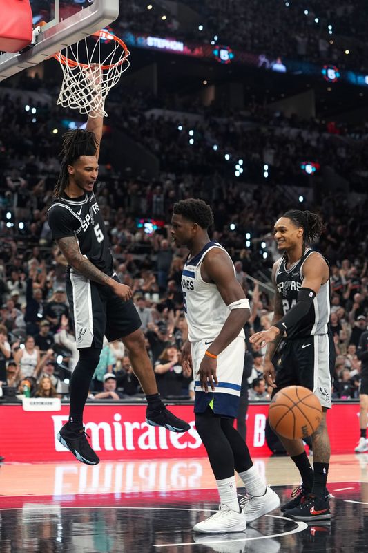 May 12, 2026; San Antonio, Texas, USA; San Antonio Spurs guard Stephon Castle (5) dunks over Minnesota Timberwolves guard Anthony Edwards (5) during the second half of game five of the second round of the 2026 NBA Playoffs at Frost Bank Center. Mandatory Credit: Scott Wachter-Imagn Images