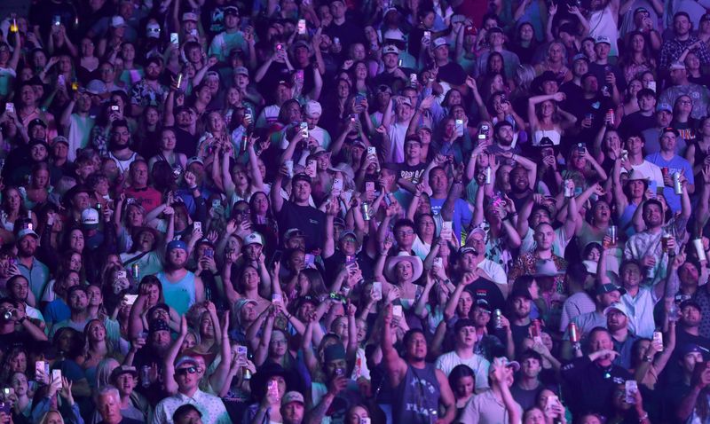 Fans cheer during the Luke Combs concert May 16 at Lambeau Field in Green Bay.
