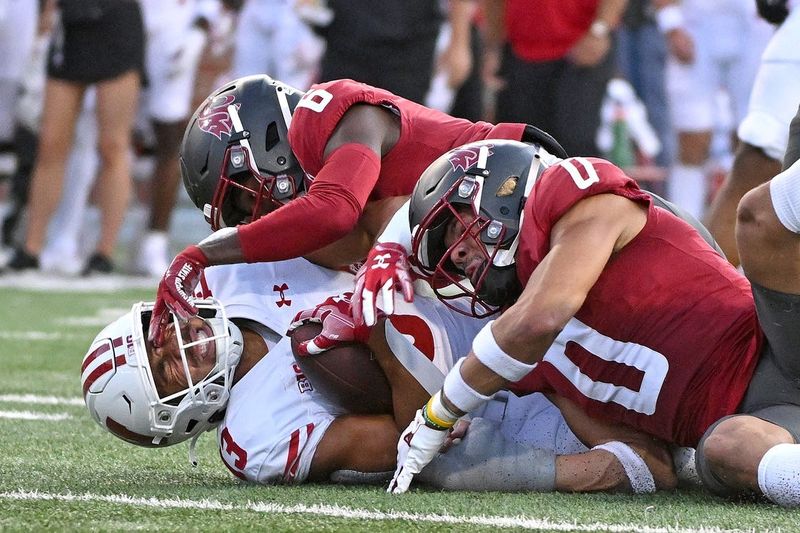 Sep 9, 2023; Pullman, Washington, USA; Wisconsin Badgers wide receiver Keontez Lewis (3) is tackled by Washington State Cougars defensive back Chau Smith-Wade (6) and Washington State Cougars defensive back Sam Lockett III (0) in the second half at Gesa Field at Martin Stadium. Washington State won 31-22. Mandatory Credit: James Snook-USA TODAY Sports