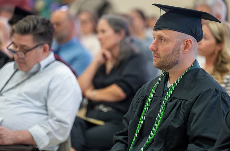 Thomas Brinkman listens to speakers during a college commencement ceremony Monday, May 18, 2026, at the Oakhill Correctional Institution in Oregon, Wisconsin. The University of Wisconsin-Green Bay conferred 15 bachelor's degrees and eight associate degrees to inmates at the minimum security prison. Brinkman earned a bachelor of arts degree.