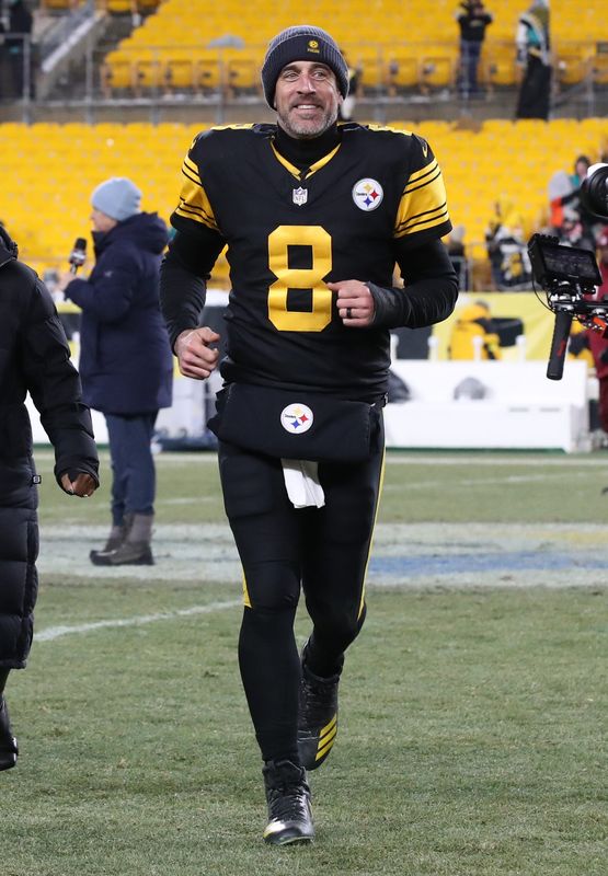 Pittsburgh Steelers quarterback Aaron Rodgers (8) runs off the field after the game against the Miami Dolphins at Acrisure Stadium in Pittsburgh on Dec. 15, 2025.