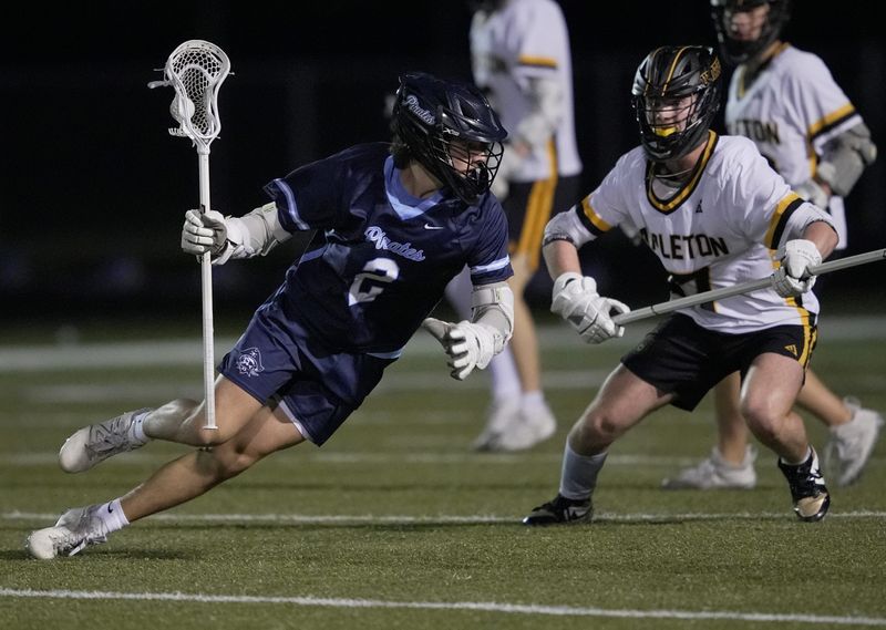 Bay Port High School's Devin Fry (2) looks to get past Appleton United's Evan Burger (17) during their boys lacrosse gameTuesday, May 19, 2026, in Appleton, Wisconsin. Appleton United won 12-8.
