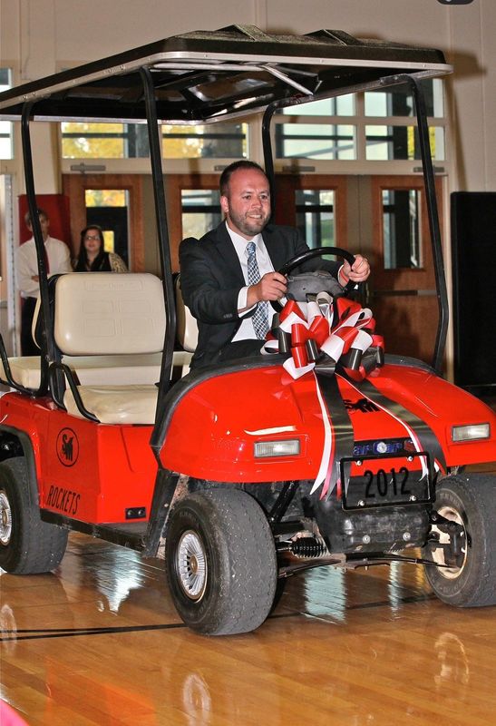 South Milwaukee High School athletic director Ante Udovicic tests out a golf cart in South Milwaukee High School's Sullivan Gymnasium during the school's 2012 graduation ceremony. That year's senior class got the golf cart for Udovicic as its senior class gift.