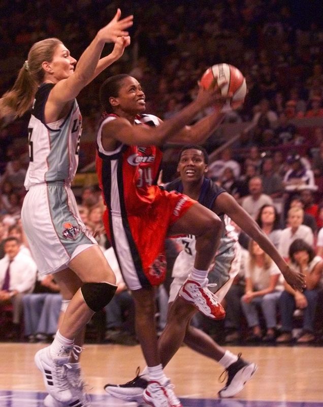 Sonja Henning, right, of the Houston Comets drives to the basket against Sue Wick of the New York Liberty during a WNBA Finals game Sept. 2, 1999, at Madison Square Garden in New York.