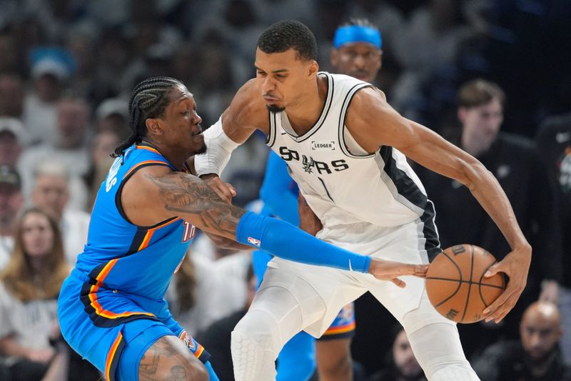 Oklahoma City Thunder guard Jalen Williams (8) defends San Antonio Spurs forward Victor Wembanyama (1) during Game 2 of the Western Conference Finals between the Oklahoma City Thunder and the San Antonio Spurs at Paycom Center in Oklahoma City, Wednesday, May 20, 2026. Oklahoma City won 122-113.