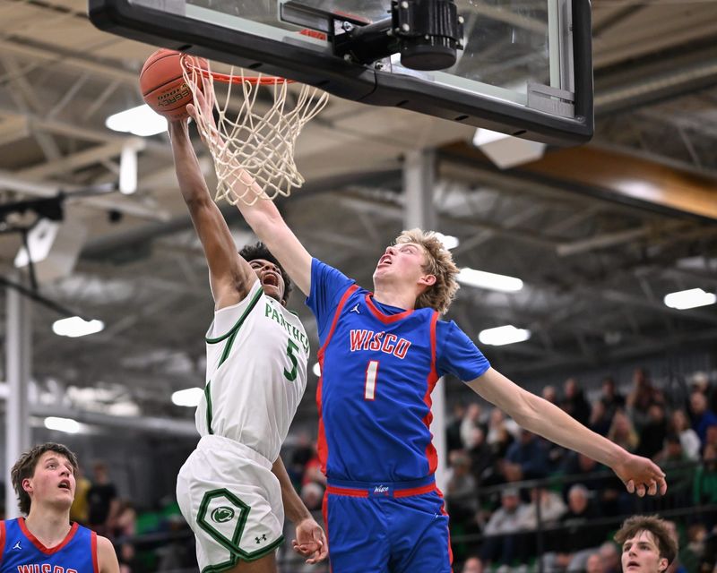 Wisconsin Lutheran guard Kager Knueppel (1) blocks a shot by Greendale guard Zavier Castillo (5) in a game Tuesday, January 20, 2026, at Greendale High School in Greendale, Wisconsin.